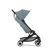 Profil wózka spacerowego Cybex Agis w kolorze turkusowo-niebieskim w pozycji siedzącej, z amortyzowanymi kołami i pojemnym koszem.