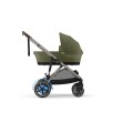 Wózek Cybex e-Gazelle z gondolą w kolorze Moss Green, widok z boku. Widoczne niebieskie strzałki symbolizujące elektryczne wspomaganie jazdy.