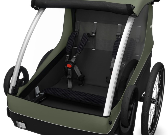 thule courier - przyczepka rowerowa - wnętrze z siedziskami i uprzężą dla dwójki dzieci - kolor vintage green (zielony) - widok od przodu