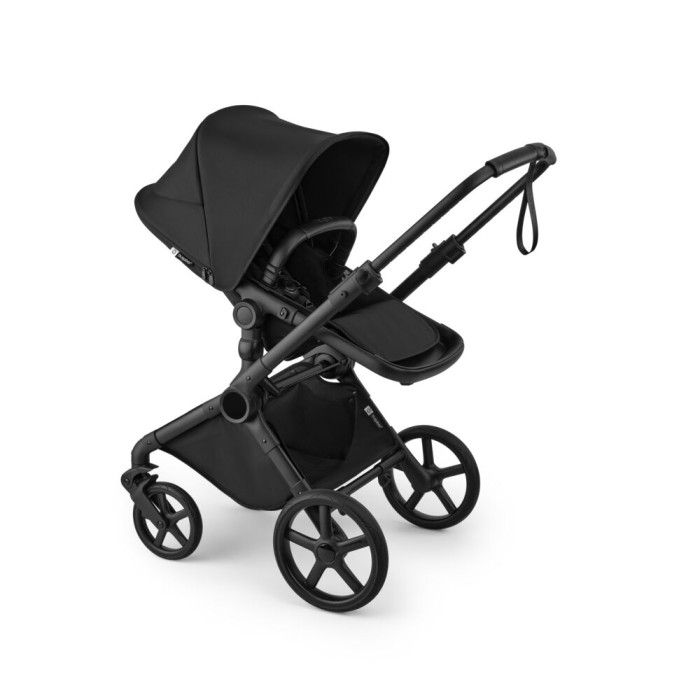 bugaboo cub - wózek dziecięcy 2w1 - wersja spacerowa, tyłem do kierunku jazdy, pozycja leżąca - widok pod skosem - kolor heritage black (czarny)