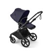 bugaboo cub - wózek dziecięcy 2w1 - wersja spacerowa, tyłem do kierunku jazdy, pozycja leżąca - widok pod skosem - kolor deep indigo (granatowy)